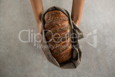 Woman holding a loaf of bread