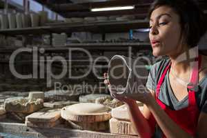 Female potter preparing mug