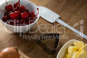 Red cherries in bowl with cookie cutter and cheese