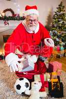 Portrait of santa with gift sack at home