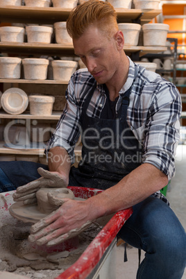 Male potter making a pot