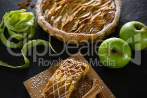 Tart and apple on concrete background