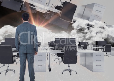 man standing in inverted office in clouds with flare