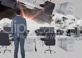 man standing in inverted office in clouds with flare