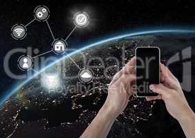 Hand holding phone with icons interface of internet of things