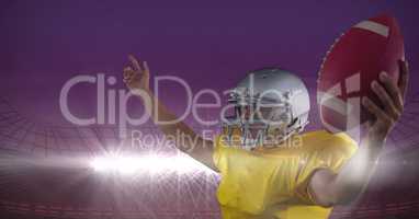 american football  player cheering with ball in his hands