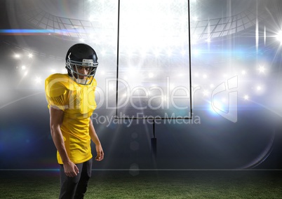 american football  player standing in stadium in front of the goal