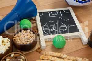 Strategy board, snacks and balls on wooden table