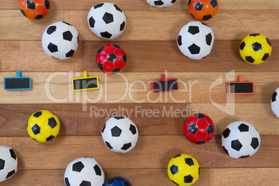 Colorful footballs on wooden table