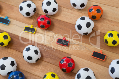 Colorful footballs on wooden table