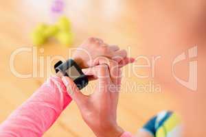 Woman using smartwatch in the gym