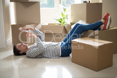 Woman using mobile phone while sleeping