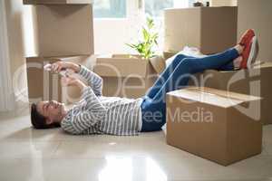 Woman using mobile phone while sleeping