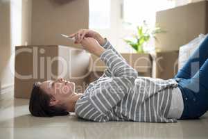 Woman using mobile phone while sleeping