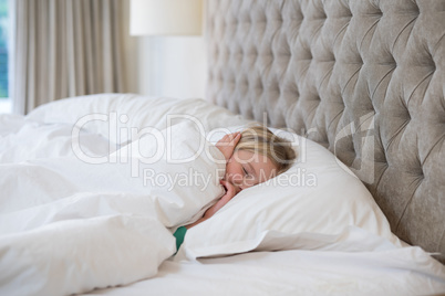 Girl sleeping on bed in bedroom