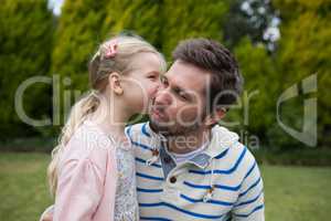 Young girl kissing her father