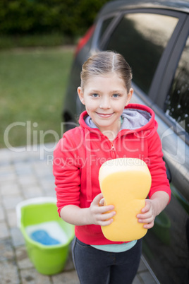 Teenage girl holding a sponge