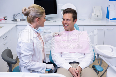 Patient looking at dentist at medical clinic