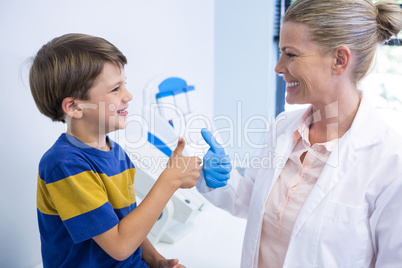 Happy dentist playing with boy