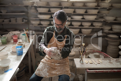 Male potter molding a clay