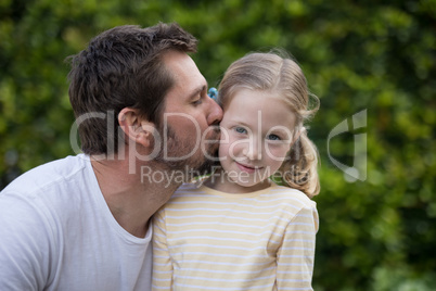 Father kissing his young girl