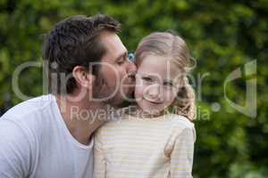 Father kissing his young girl