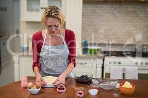 Woman preparing pan cake in kitchen