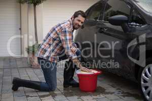 Man washing a car on a sunny day