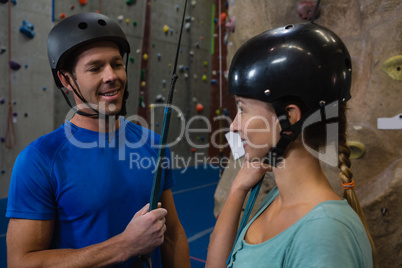 Smiling athletes in sports helmet standing at health club