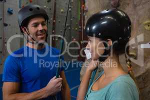 Smiling athletes in sports helmet standing at health club