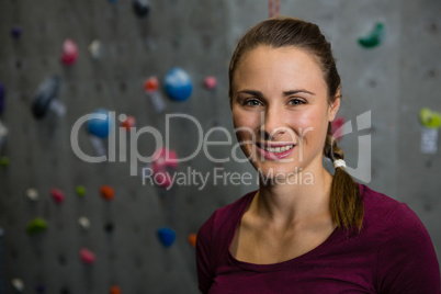 Portrait of smiling athlete standing in gym