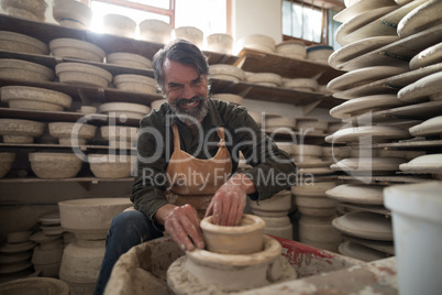 Portrait of male potter molding a clay