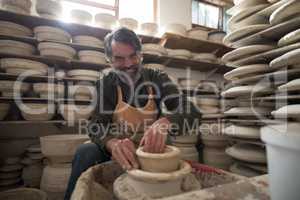 Portrait of male potter molding a clay