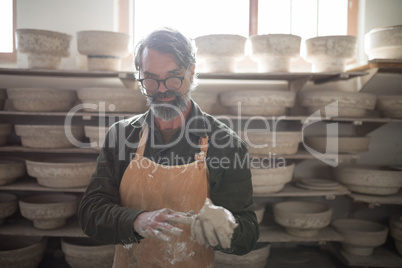 Portrait of male potter molding a clay