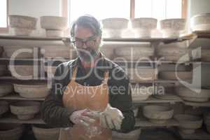 Portrait of male potter molding a clay