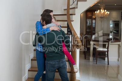 Parents and daughter hugging each other