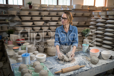 Female potter molding a clay