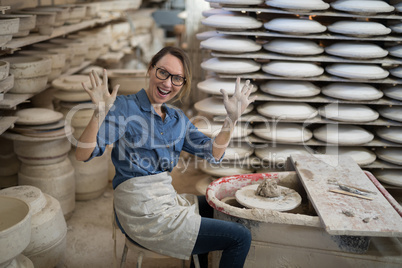 Portrait of female potter molding a clay