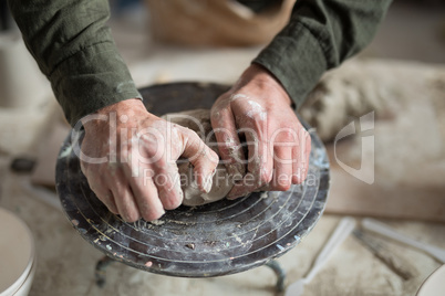 Male potter molding a clay