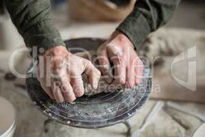 Male potter molding a clay