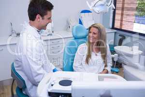 Happy patient talking with dentist