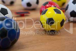 Various footballs on wooden table