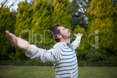 Man standing with arms wide open