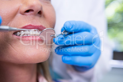 Dentist examining woman at medical clinic