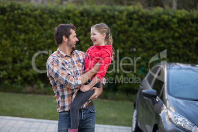 Father carrying his daughter in his arms