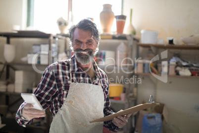 Portrait of happy potter using mobile phone Portrait of happy potter using mobile phone