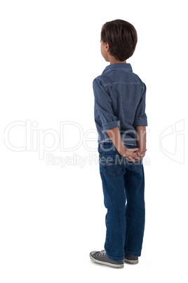 Boy standing against white background