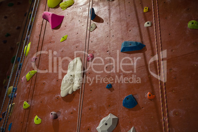 Rope hanging by climbing wall at health club