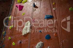 Rope hanging by climbing wall at health club
