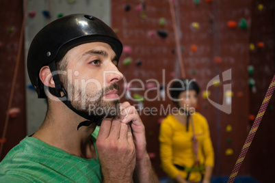 Male athlete wearing sports helmet in health club